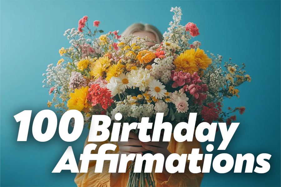 A woman smiles while holding a colorful bunch of flowers in her hands.